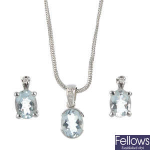 An aquamarine and diamond pendant and a pair of ear studs.