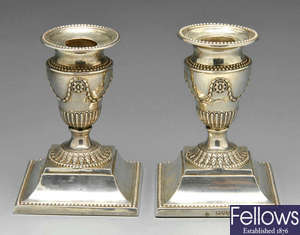 A pair of Victorian silver candlesticks in Neo-Classical style.
