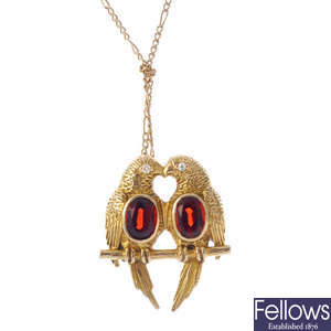A 14ct gold garnet and diamond love bird pendant.