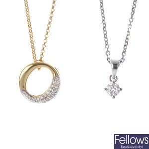 Two diamond pendants.