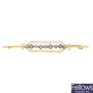 An early 20th century 15ct gold sapphire and split pearl bar brooch.