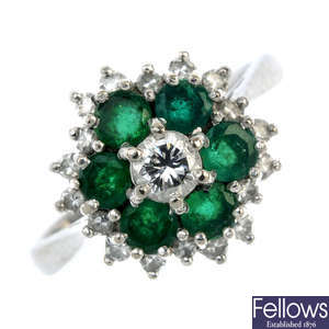 A diamond and emerald cluster ring. 
