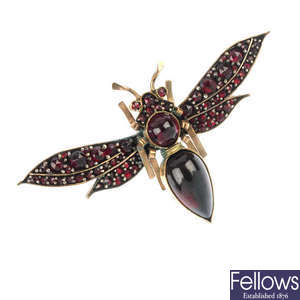 An early 20th century garnet and red paste moth brooch.
