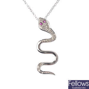 An 18ct gold diamond and ruby snake pendant. 