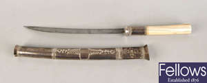 An Eastern white metal mounted dagger