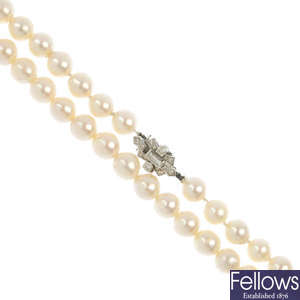 A cultured pearl single-strand necklace with diamond-set clasp.