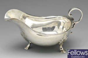 An Edwardian silver sauce boat & a 1930's example.