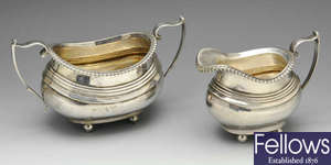 An early 20th century silver sugar bowl with matching cream jug.