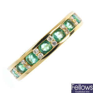 An 18ct gold emerald and diamond half-circle eternity ring.