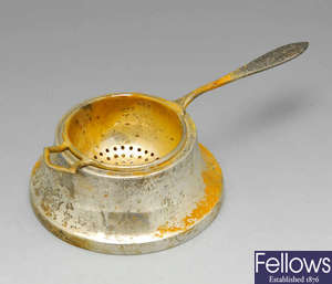 A George V silver tea strainer, etc. 