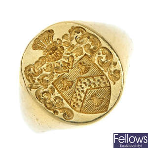 An engraved armorial signet ring.