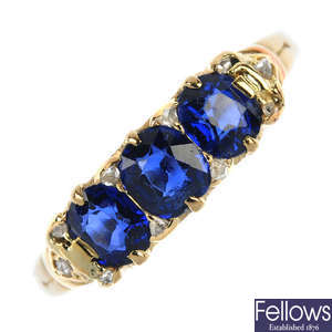 An early 20th century 18ct gold sapphire three-stone and diamond accent ring.
