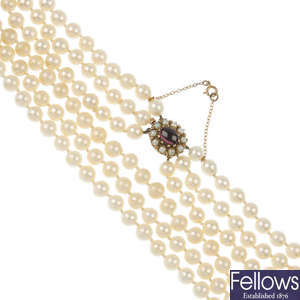 A cultured pearl three-row necklace, with garnet and seed pearl cluster clasp.