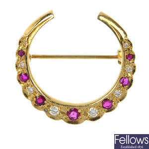 An 18ct gold ruby and diamond crescent brooch.
