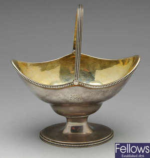 A George III silver swing handled sugar basket.