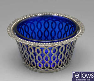An Edwardian silver sugar dish with blue glass liner.