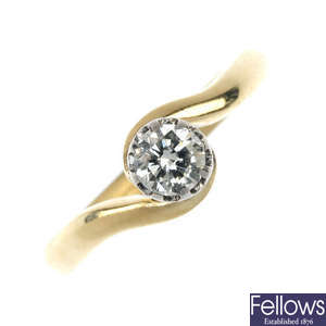 A mid 20th century 18ct gold and platinum diamond single-stone crossover ring.