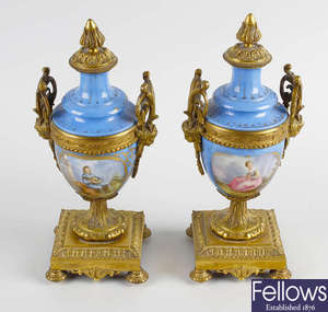 A pair of ormolu mounted porcelain urns