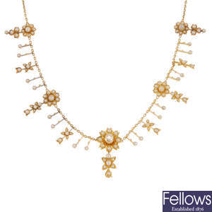 An early 20th century gold diamond and split pearl fringe necklace.