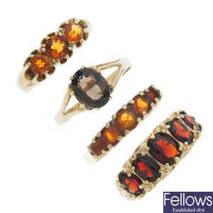 A selection of four 9ct gold gem-set dress rings.