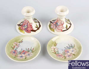 A pair of Moorcroft candlesticks, plus a pair of dishes. 