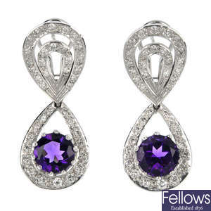 A pair of amethyst and diamond ear pendants.