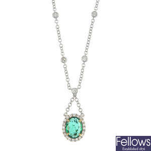 A diamond and emerald pendant.