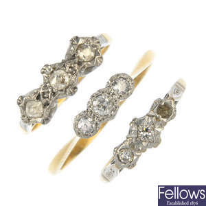 A selection of three diamond three-stone rings.