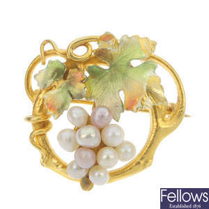 An early 20th century gold seed pearl and enamel foliate brooch.