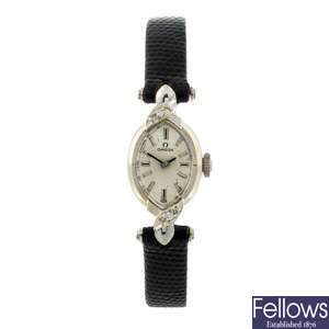 OMEGA - a lady's white metal wrist watch.