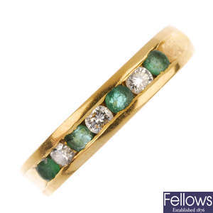 An emerald and diamond band ring.