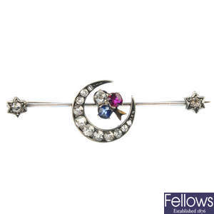 A sapphire ruby and diamond crescent bar brooch.
