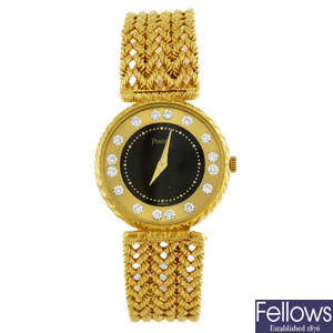 PIAGET - a lady's yellow metal bracelet watch.