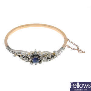 An early 20th century silver and 18ct gold sapphire and diamond hinged bangle.