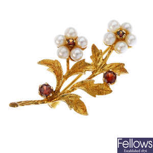 A 9ct gold garnet and seed pearl floral brooch and a paste pendant.