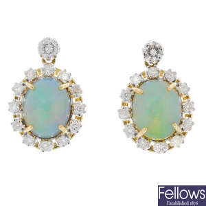 A pair of opal and diamond ear pendants.