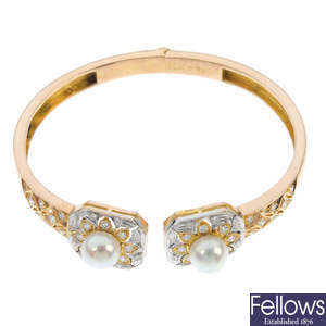 A 14ct gold cultured pearl and diamond hinged bangle.