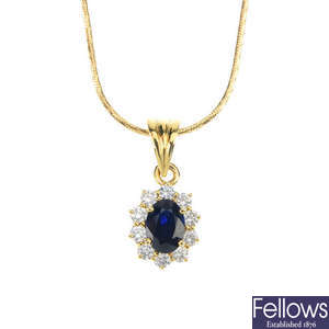 A sapphire and diamond cluster pendant and chain.