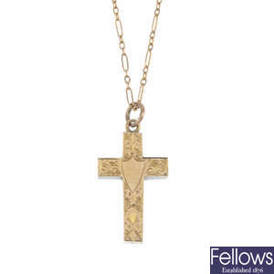 A 9ct gold cross pendant and a selection of three charms. 