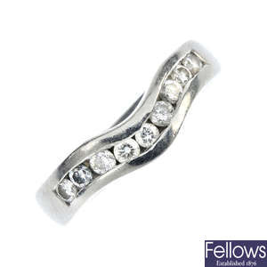A platinum diamond curved band ring.