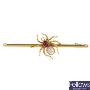 An early 20th century 15ct gold gem-set spider brooch.