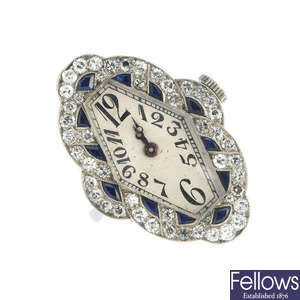 An Art Deco platinum sapphire and diamond ring watch.