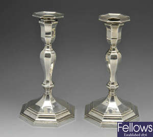 A pair of Edwardian octagonal silver candlesticks.