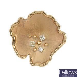 A diamond abstract flower brooch.
