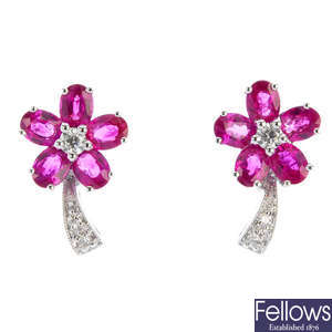 A pair of ruby and diamond floral earrings.