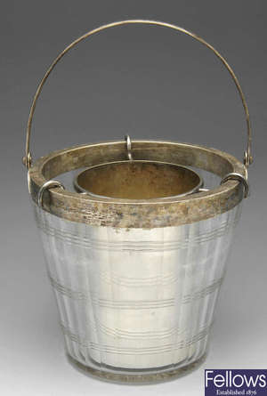 An Edwardian silver mounted ice bucket/wine cooler with plated liner insert.