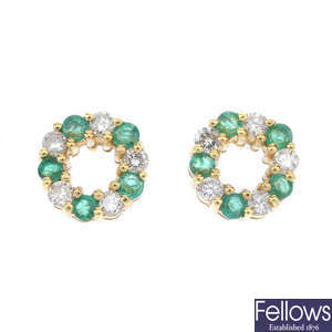 A pair of 18ct gold diamond and emerald ear studs.
