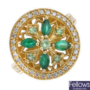 An emerald, diamond and gem-set cluster ring.