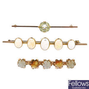 A selection of five mostly gem-set brooches.