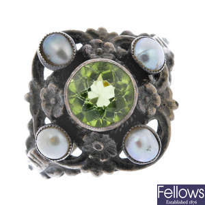 An Arts and Crafts silver peridot and split pearl dress ring.